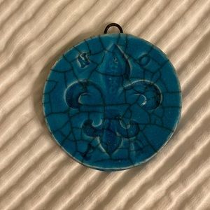 Ceramic fleur-de-lis ornament.